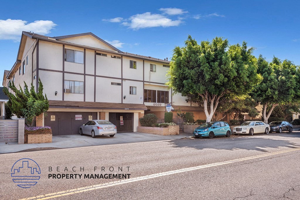 a street view of a building with cars parked in front