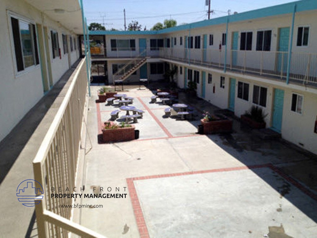 a view of the courtyard from the balcony of an apartment building