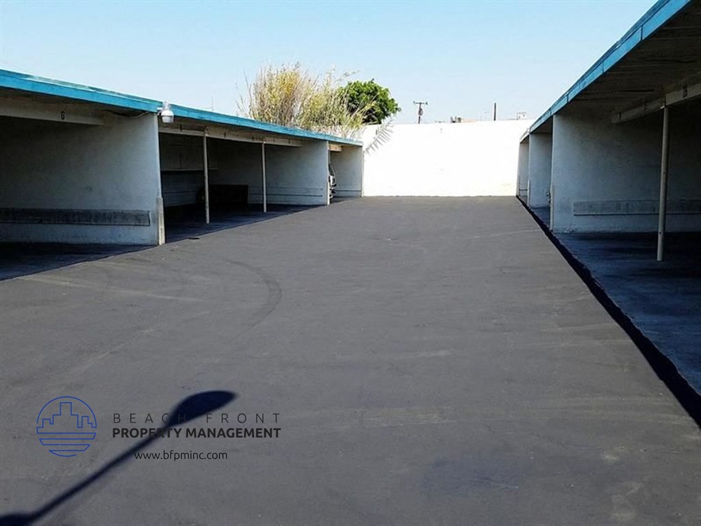 an empty parking garage with a clear blue sky