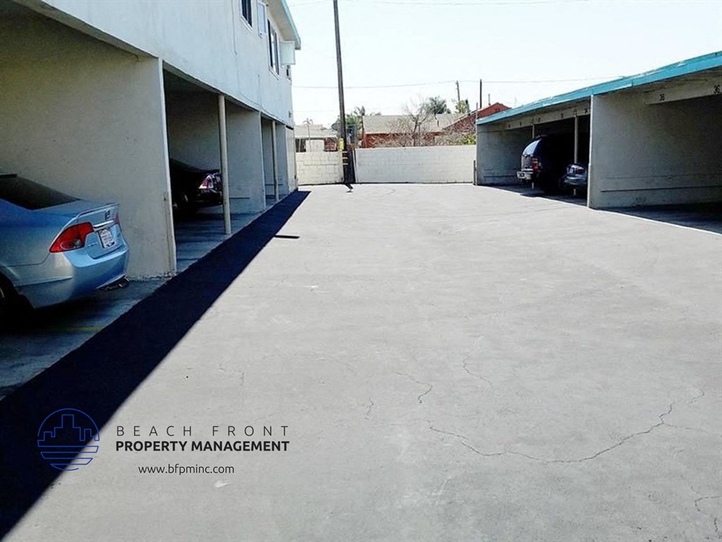 a parking lot with cars parked next to a building