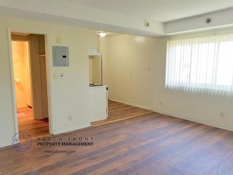 the living room and dining room of an empty apartment