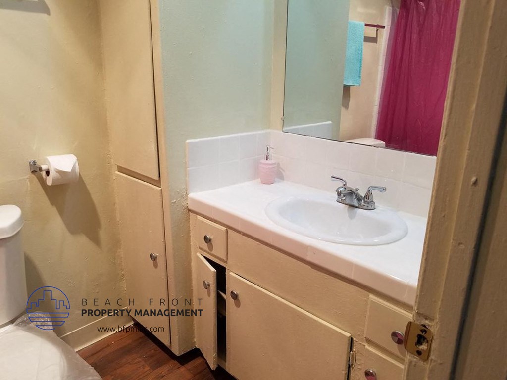 a bathroom with a sink and a mirror and a toilet
