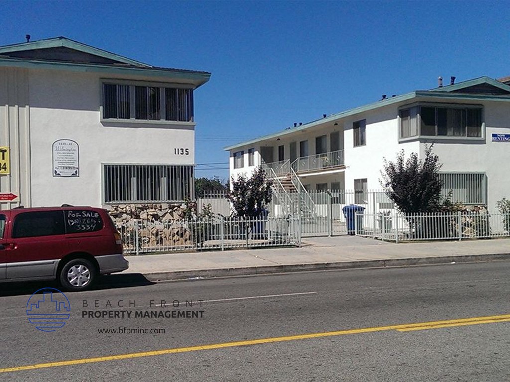 a red van parked in front of an apartment building
