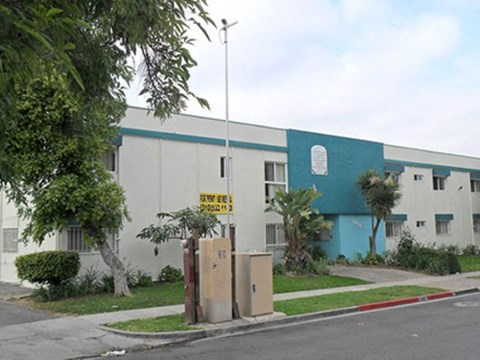 a blue and white building with boxes in front of it