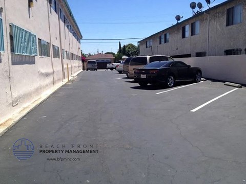 an empty parking lot with cars parked in it