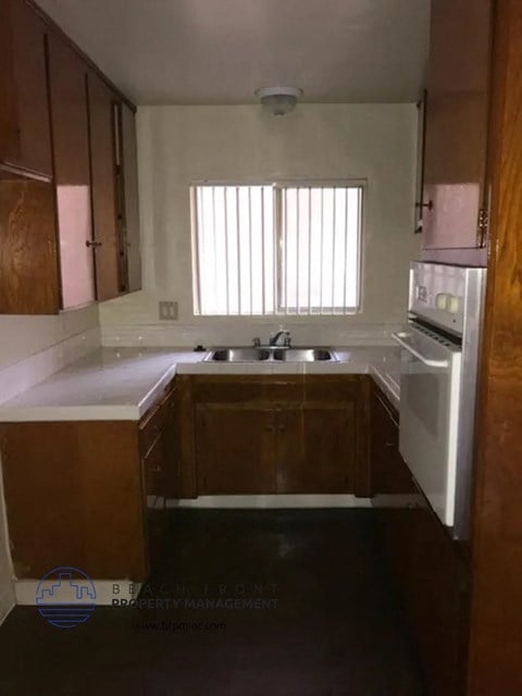 a kitchen with a sink and a stove and a window