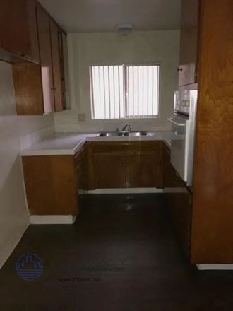 an empty kitchen with a sink and a window