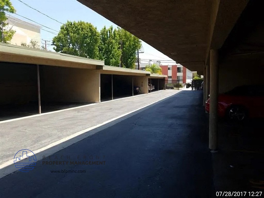 a parking lot with a car parked under a building