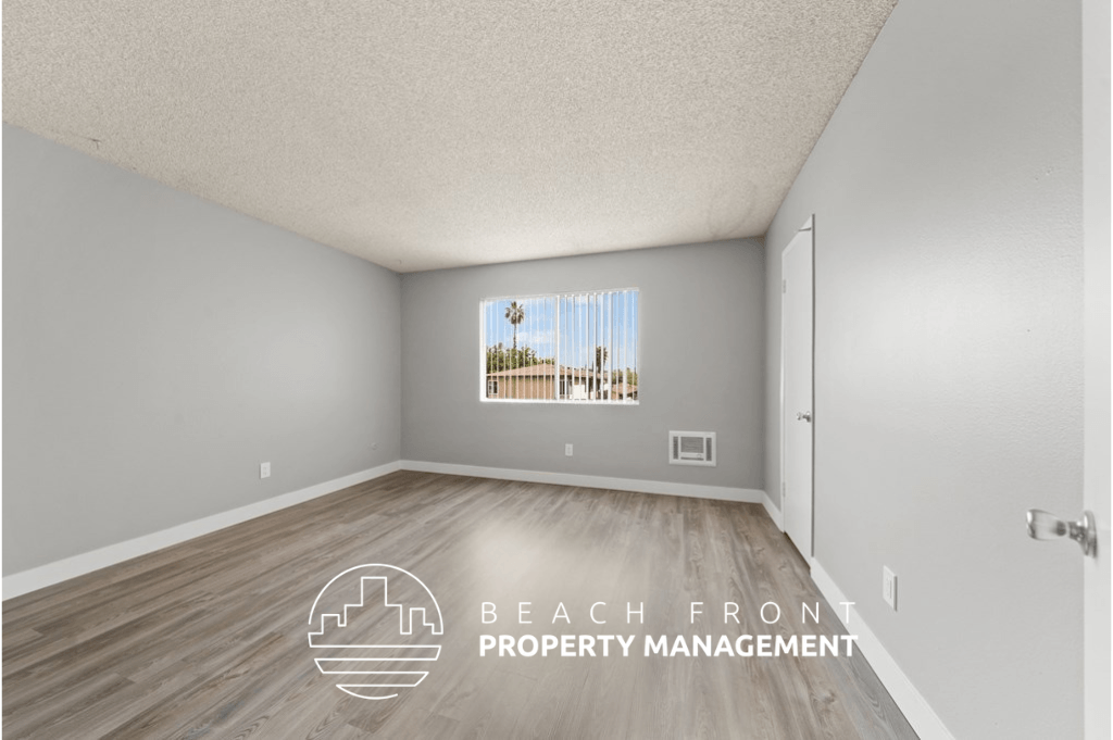 a living room with wood flooring and a door to a balcony