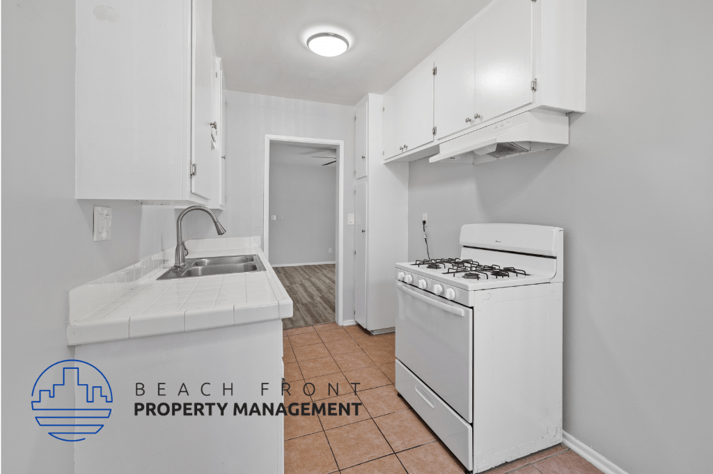 a kitchen with a stove and a sink and a refrigerator