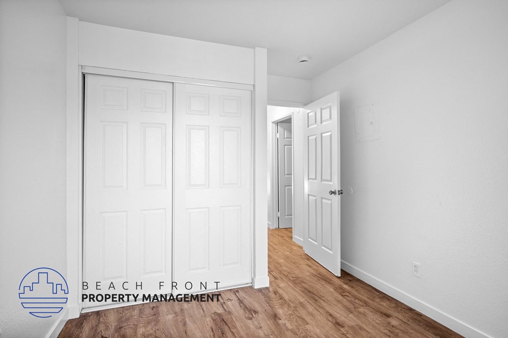 a bedroom with two closets and a door to a hallway