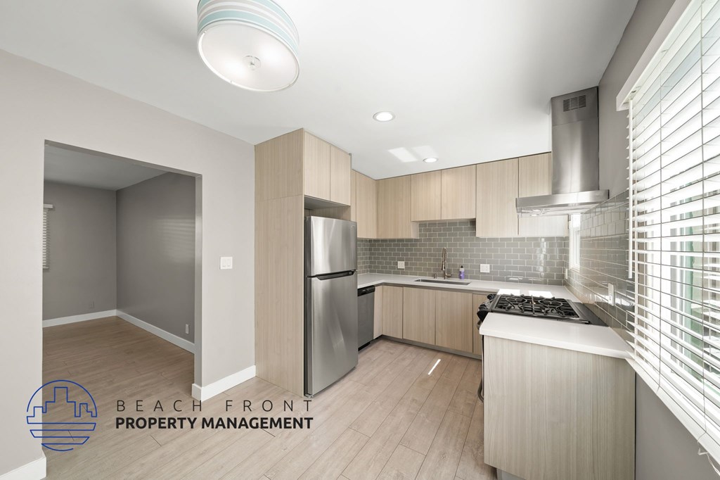 A modern kitchen with wooden cabinets and stainless steel appliances.