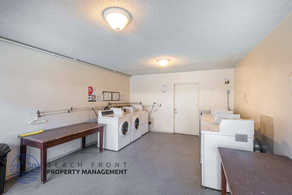 a laundry room with washing machines and a table