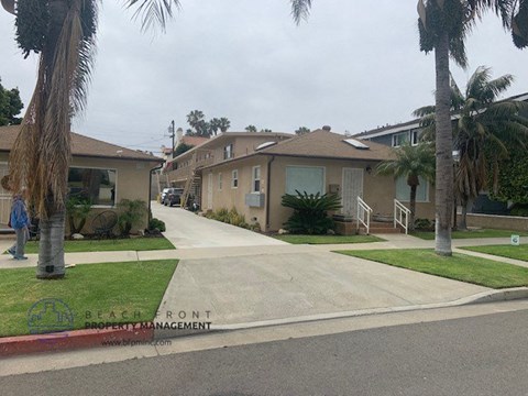 a row of houses on a street with palm trees