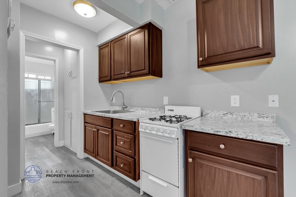 a kitchen with dark wood cabinets and white appliances