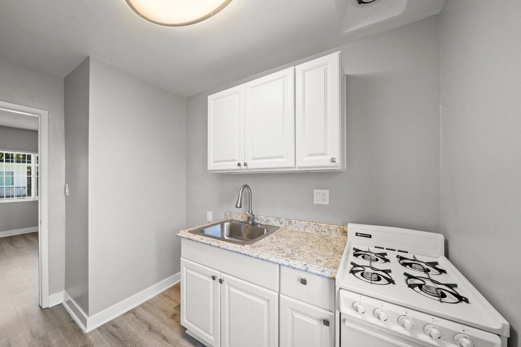 the kitchen in a new home with white appliances and white cabinets