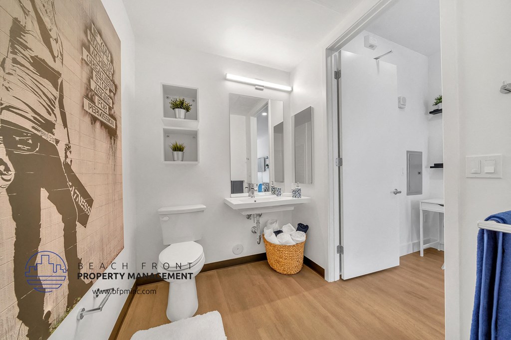 a bathroom with a toilet and a sink and a shower