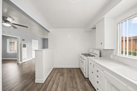 a renovated kitchen with white cabinets and white appliances