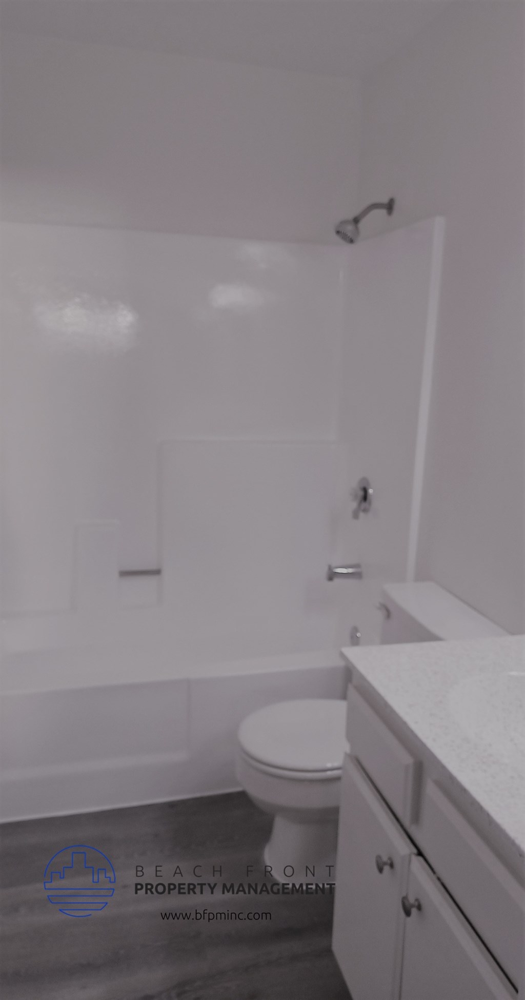 a white bathroom with a toilet and a tub