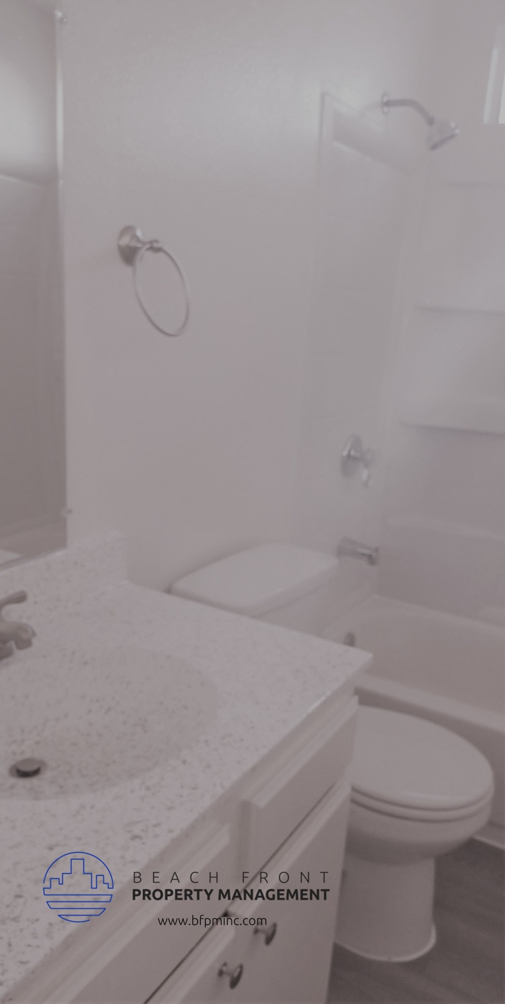 a white bathroom with a toilet and a sink