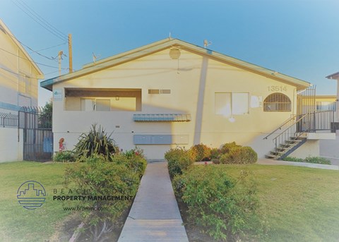a house with a yard and a sidewalk in front of it