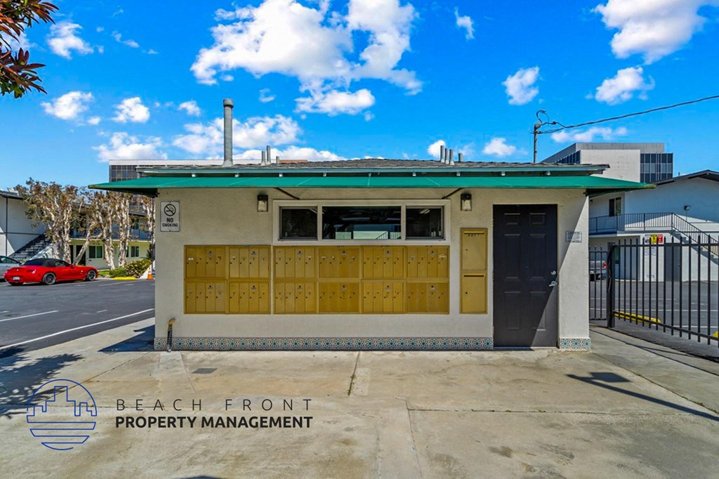 the front of a building with a parking lot