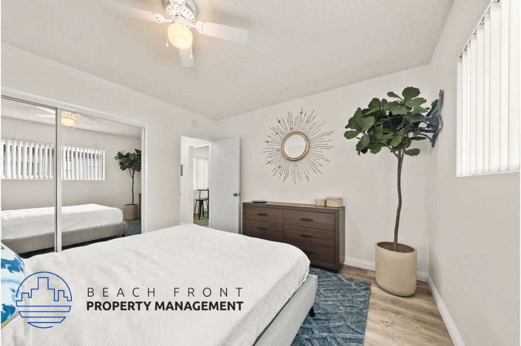 a bedroom with a white bed and a large plant