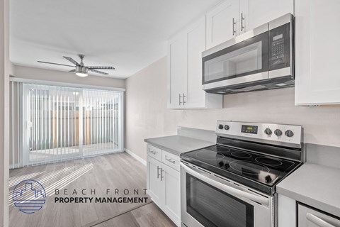 A kitchen with a stove top oven and microwave above it.