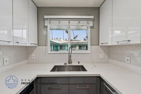 A kitchen with a sink and a window.