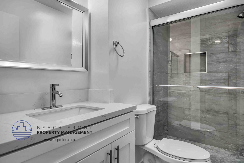 a bathroom with a toilet sink and shower