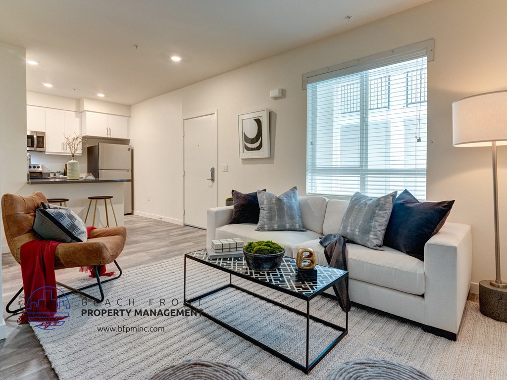 an open living room with a white couch and a coffee table