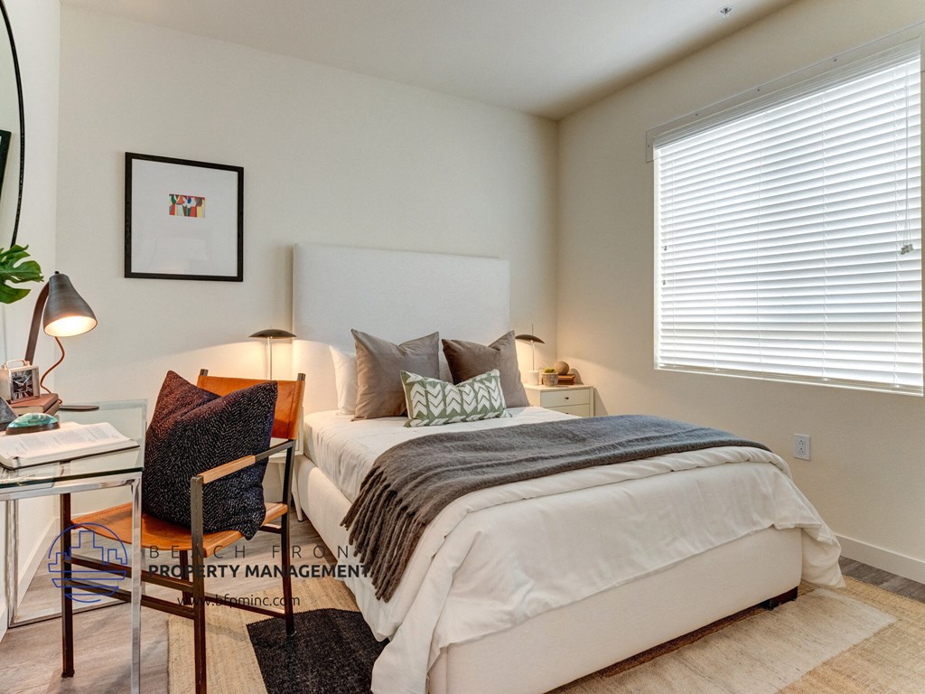 a bedroom with a bed and a desk with a chair