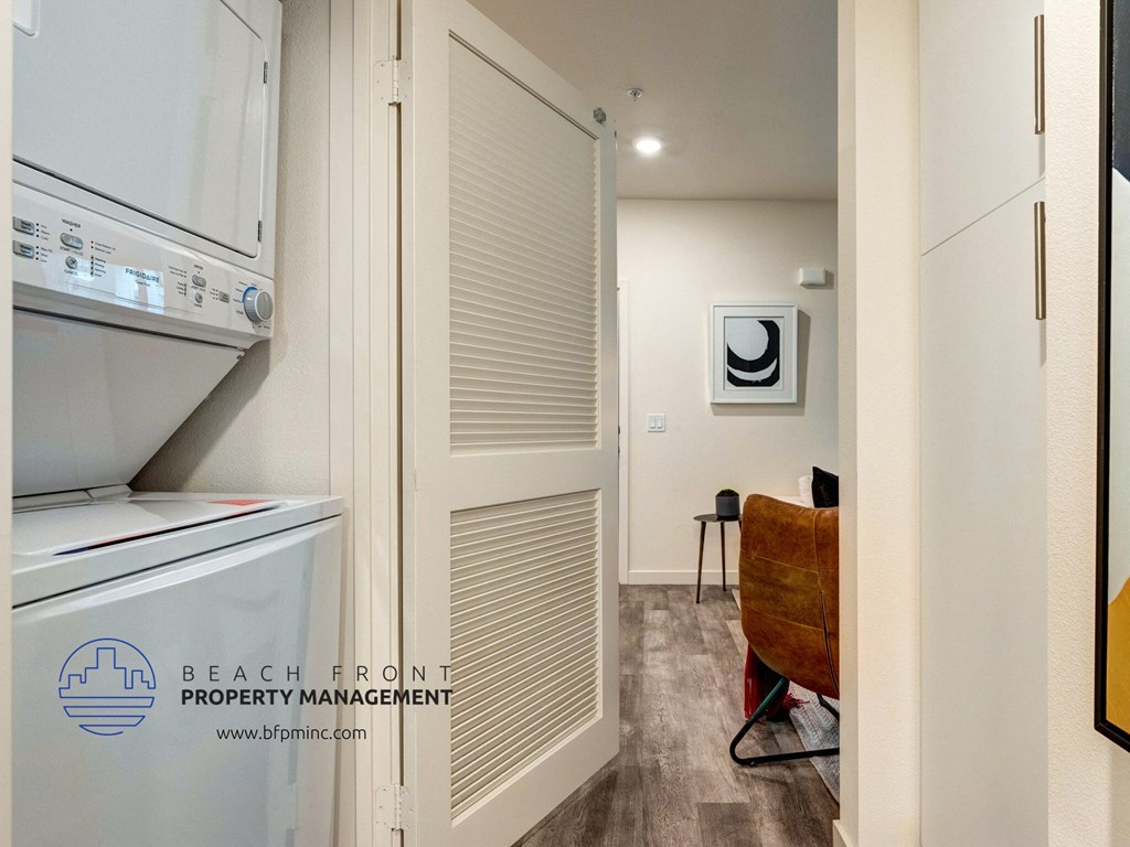 a laundry room with a washer and dryer and a door to a closet