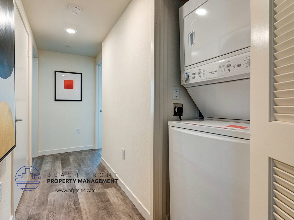 a laundry room with a washer and dryer and a refrigerator
