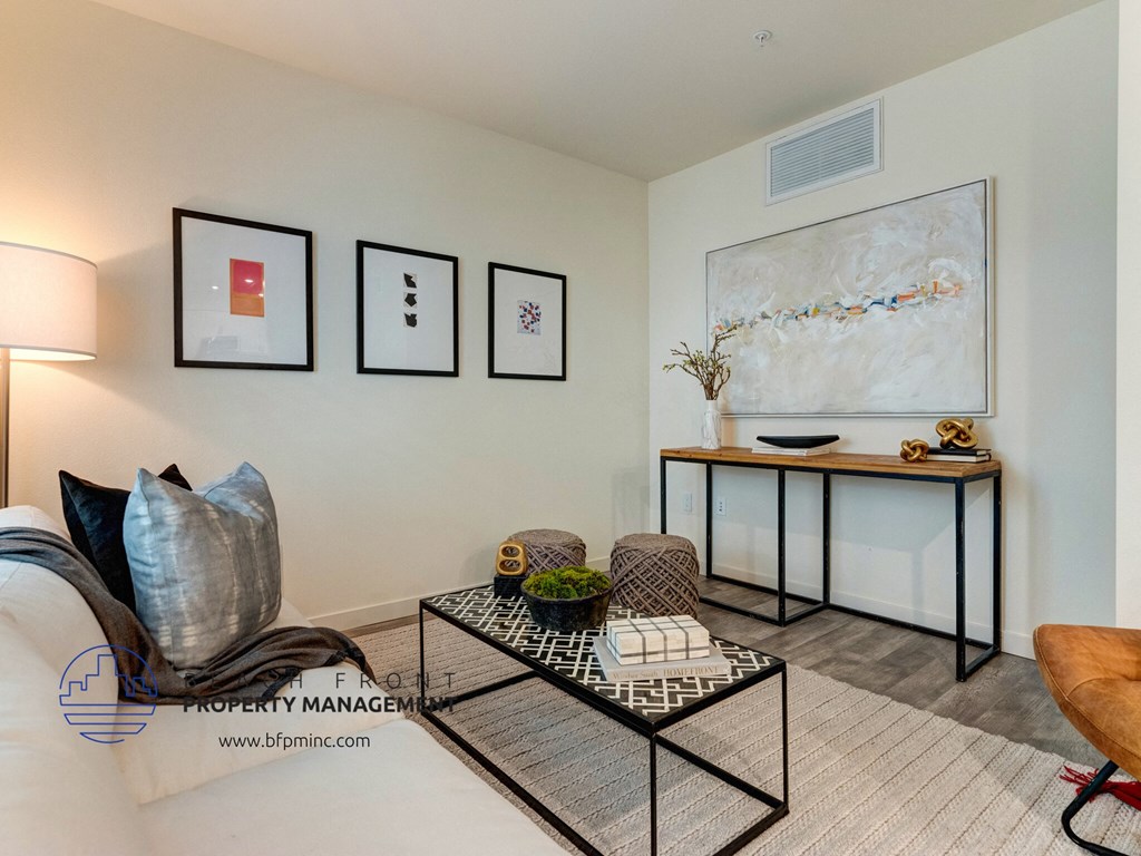 a living room with a couch and a table and pictures on the wall