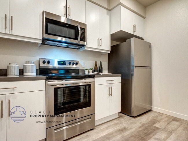 a kitchen with stainless steel appliances and white cabinets
