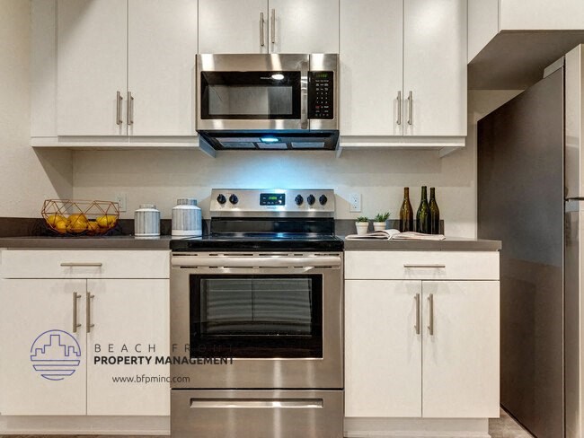 a kitchen with stainless steel appliances and white cabinets