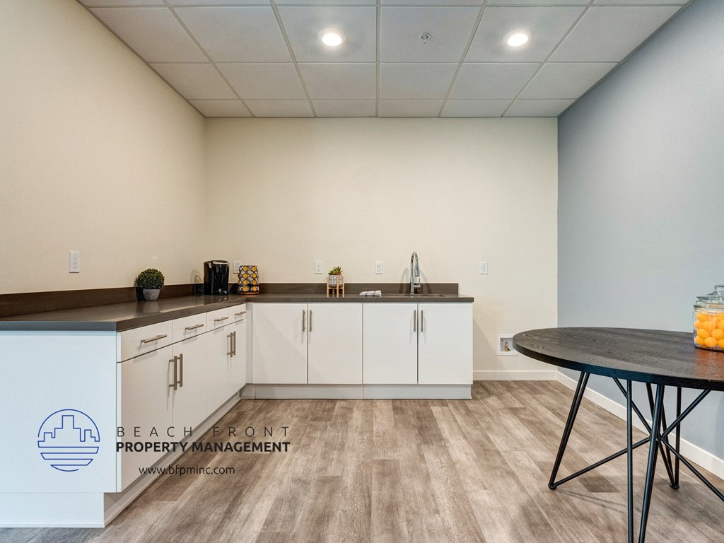 a kitchen with white cabinets and a table