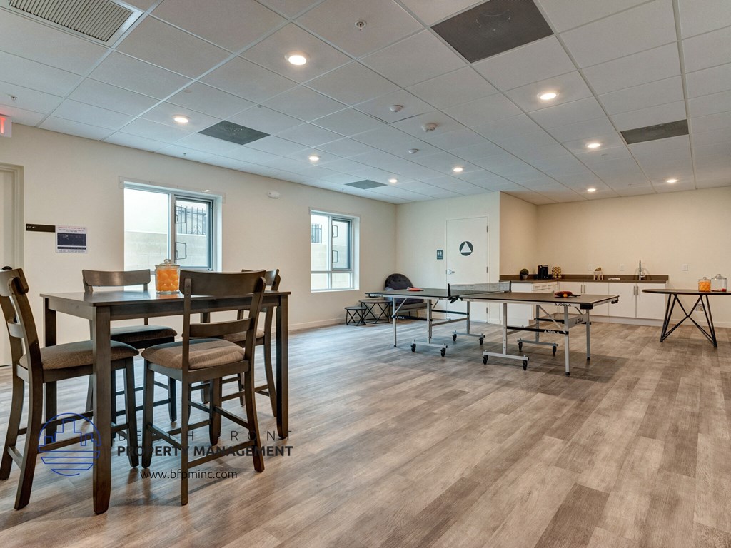 an empty conference room with tables and chairs and a projection screen