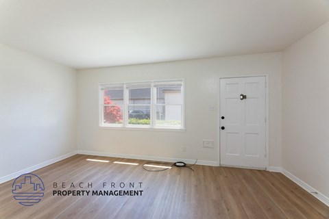 a living room with white walls and a white door