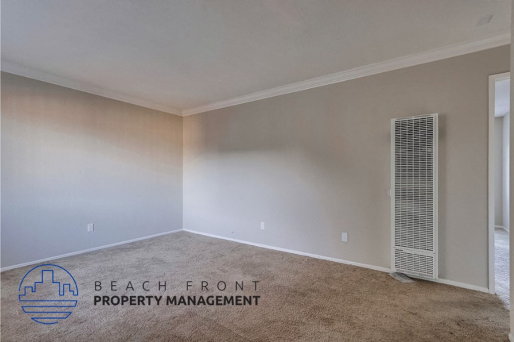 an empty room with a heater on the wall