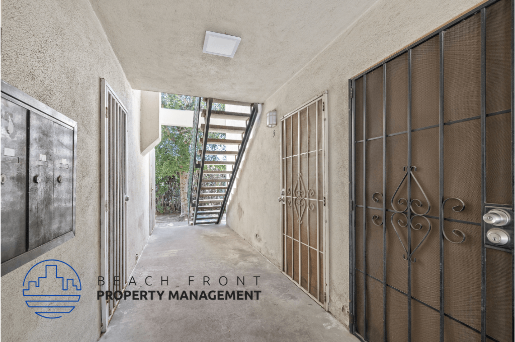 a stairway in a building with a metal door and a metal staircase