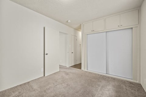 A room with white walls and a carpeted floor.