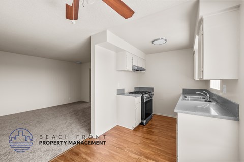 A kitchen with a stove top oven and a sink.