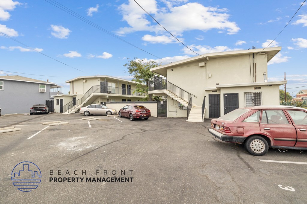 a parking lot with cars in front of a building