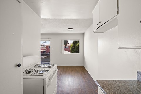 A kitchen with a stove and a window.