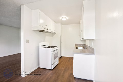 A small kitchen with white appliances and cabinets.