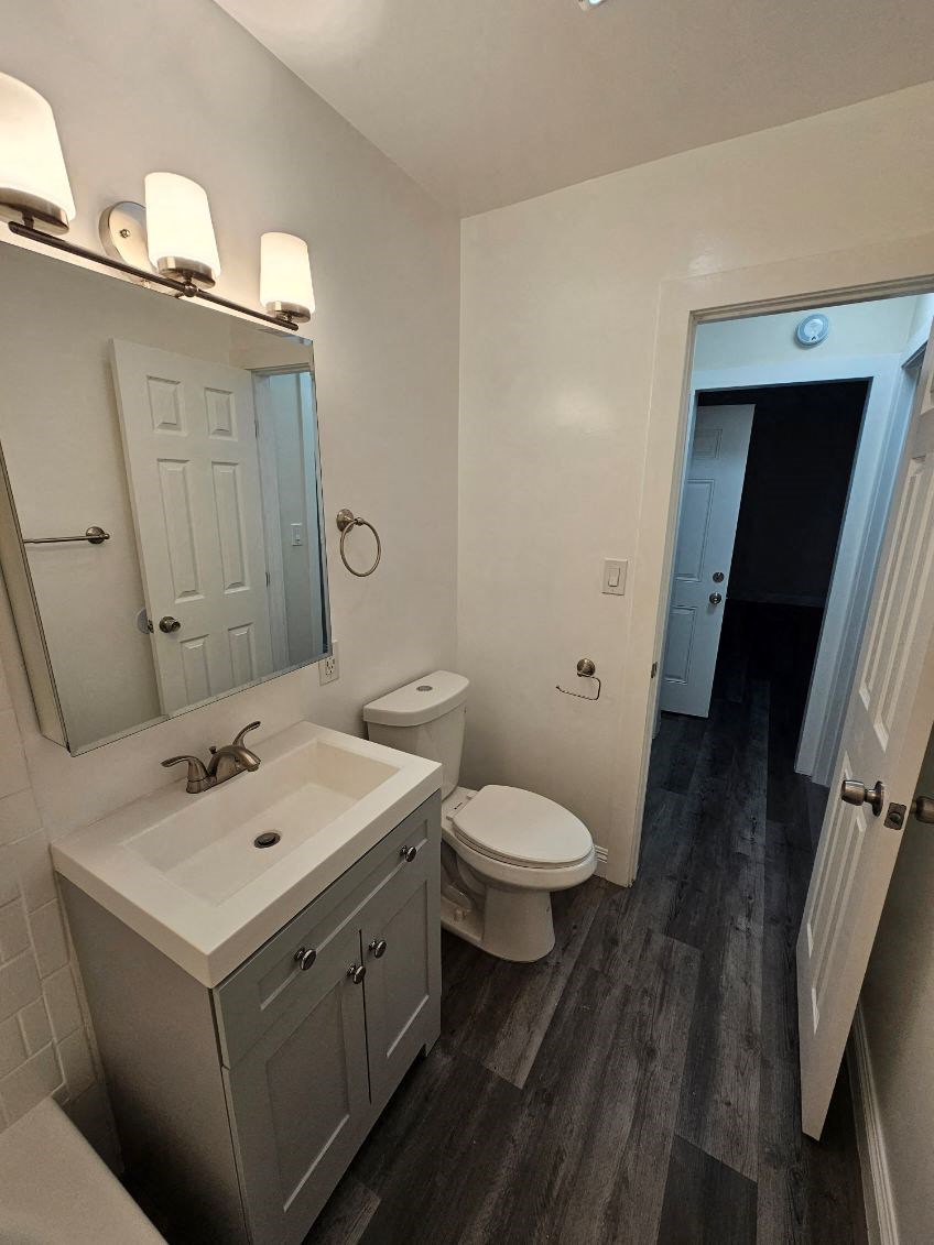 a bathroom with a toilet and a sink and a mirror