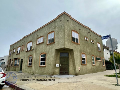 A building with a sign that says Beach Front Property Management.