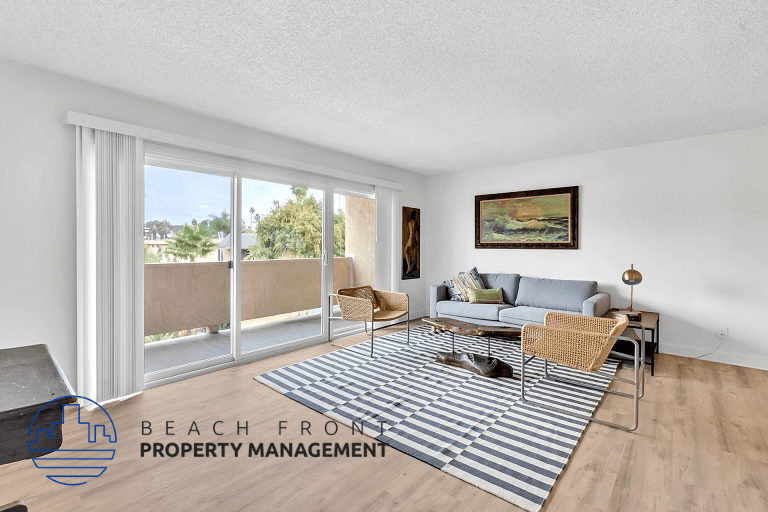 a living room with a couch and a rug and sliding glass doors